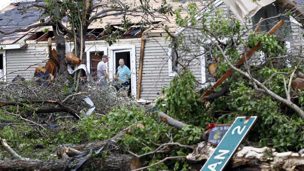 A man and woman talk at the entrance of a house that was destroyed after a tornado swept through the area the previous night in Van, Texas on May 11, 2015. (Photo by Mike Stone/Reuters)