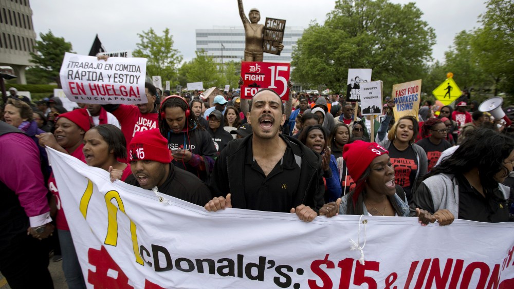 People protest outside of the McDonald's headquarters in Oak Brook, Ill., May 20, 2015. The demonstrators were calling for higher wages and better work conditions. (Photo by Andrew Nelle/Reuters)