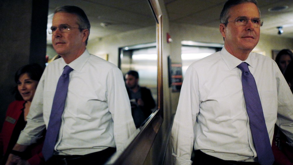 Potential 2016 Republican presidential candidate and former Florida Governor Jeb Bush is reflected in a mirror as he departs after speaking to the Greater Salem Chamber of Commerce in Salem, N.H. May 21, 2015. (Photo by Brian Snyder/Reuters)
