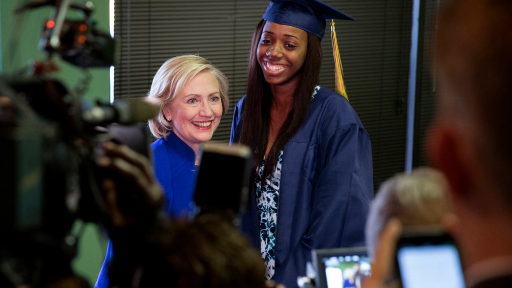 Democratic presidential candidate Hillary Clinton has her picture taken with Keenan High School graduate Dayzjohna Roberts at Kiki's Chicken and Waffles restaurant in Columbia, S.C., May 27, 2015. (Photo by Chris Aluka Berry/Reuters)