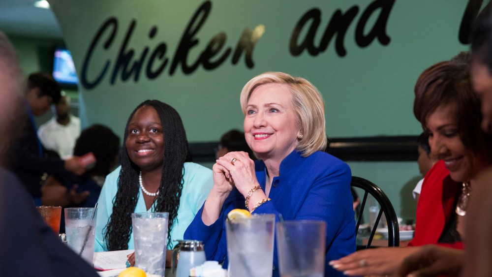 Hillary Clinton talks with people assembled to meet her while sitting with business leaders Kiki Smith Cyrus (L) and Cynthia Hardy (R) at Kiki's Chicken and Waffles restaurant in Columbia, S.C. on May 27, 2015. (Photo by Christopher Aluka Berry/Reuters)