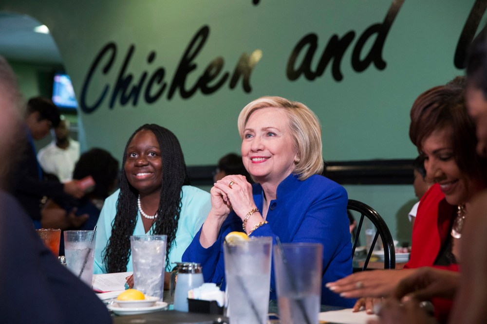 Hillary Clinton talks with people assembled to meet her while sitting with business leaders Kiki Smith Cyrus (L) and Cynthia Hardy (R) at Kiki's Chicken and Waffles restaurant in Columbia, S.C. on May 27, 2015. (Photo by Christopher Aluka Berry/Reuters)