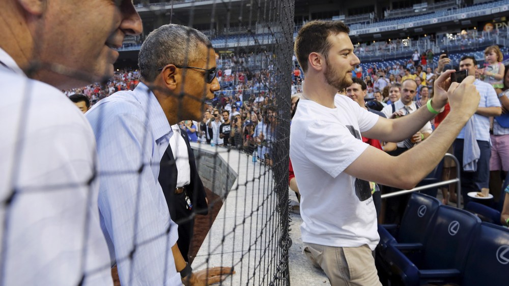 U.S. President Barack Obama interacts with fans at the annual Congressional Baseball Game, pitting Republicans against Democrats for charity, at Nationals Park in Washington June 11, 2015. (Photo by Jonathan Ernst/Reuters)