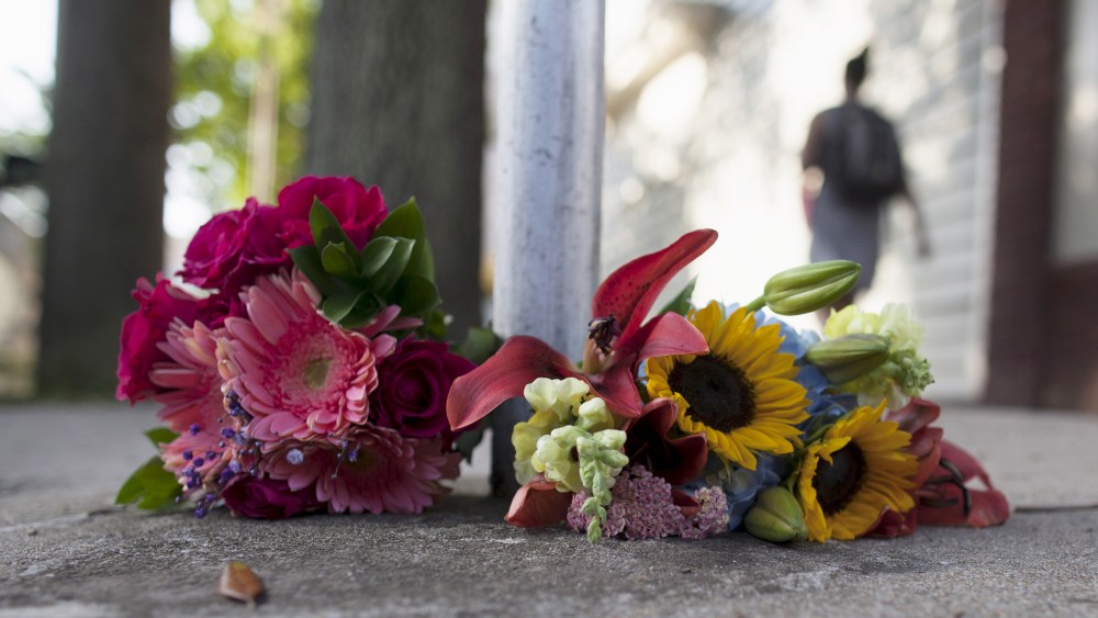 Flowers for the victims of Wednesday's shootings, are laid near a police barricade in Charleston, S.C., June 18, 2015, while police continue the search for suspected gunman, Dylann Roof. (Photo by Randall Hill/Reuters)
