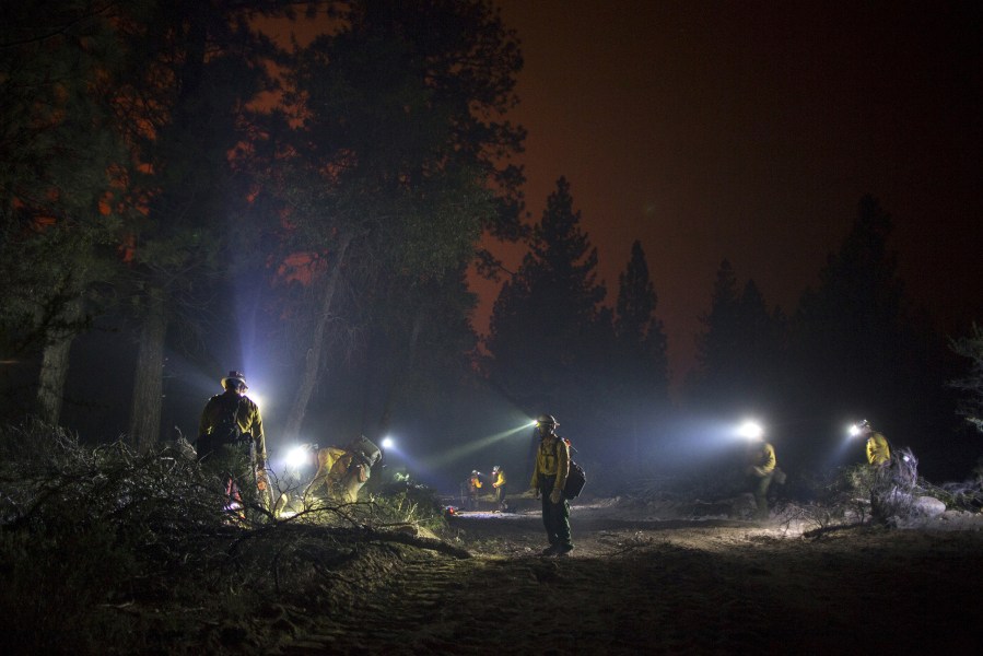 Members of El Carrizo Hot Shots crew cut fire a line through the night to try to contain the Lake Fire in the San Bernardino National Forest, Calif., June 19, 2015.  (Photo by David McNew/Reuters)