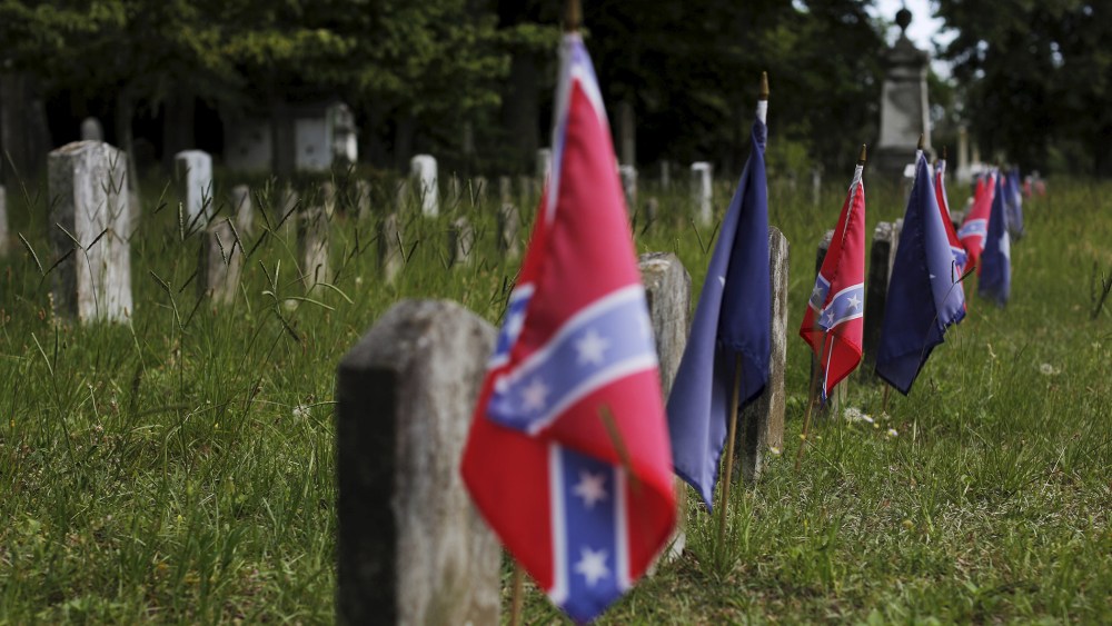 Confederate battle flags mark the graves of soldiers in the Confederate States Army in the U.S. Civil War in Magnolia Cemetery in Charleston