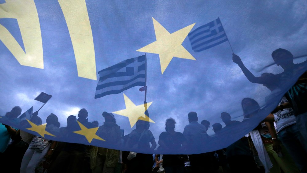 Pro-Euro protestors hold Greek national flags during a pro-Euro rally in front of the parliament building, in Athens, Greece, June 30, 2015. (Photo by Yannis Behrakis/Reuters)