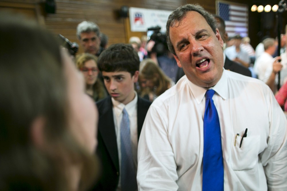 New Jersey governor and Republican presidential candidate Chris Christie speaks with supporters after a town hall event in Sandown
