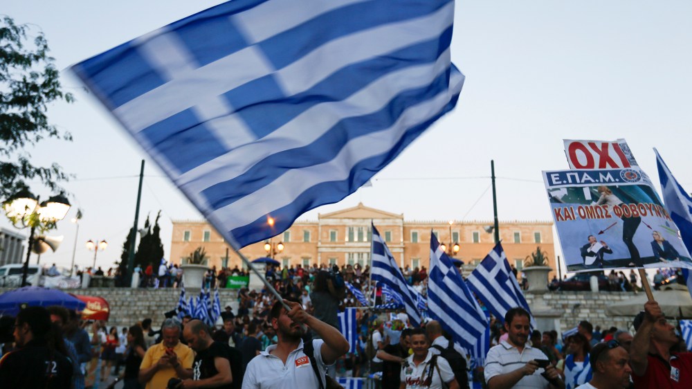 Anti-austerity 'No' voters celebrate the results of the first exit polls in front of the Greek parliament in Syntagma Square in Athens, Greece on July 5, 2015. (Photo by Yannis Behrakis/Reuters)