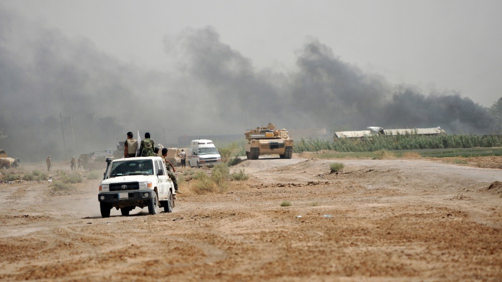 Iraq's Shi'ite paramilitaries and members of Iraqi security forces gather at North of Fallujah in province of Anbar, July 6, 2015. (Photo by Stringer/Reuters)