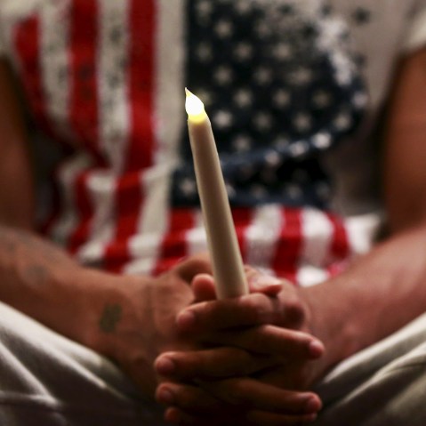 A family member of Eric Garner holds a candle during the Interfaith Prayer Service for Healing and Reconciliation at the Mount Sinai United Christian Church in the Staten Island borough of New York