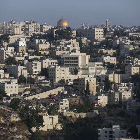 The Arab East Jerusalem neighbourhood of Ras al-Amud is seen in front of the Dome of the Rock