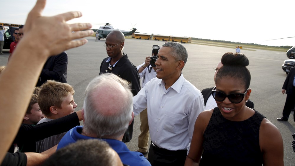 U.S. President Barack Obama and first lady Michelle Obama greet well wishers upon their arrival in Martha's Vineyard