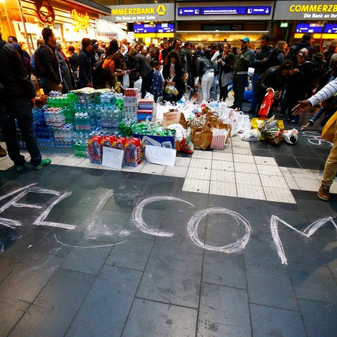 People wait for migrants expected to arrive at the railway station in Frankfurt, Germany, Sep. 5, 2015. Austria and Germany threw open their borders to thousands of exhausted migrants on Saturday. (Photo by Kai Pfaffenbach/Reuters)