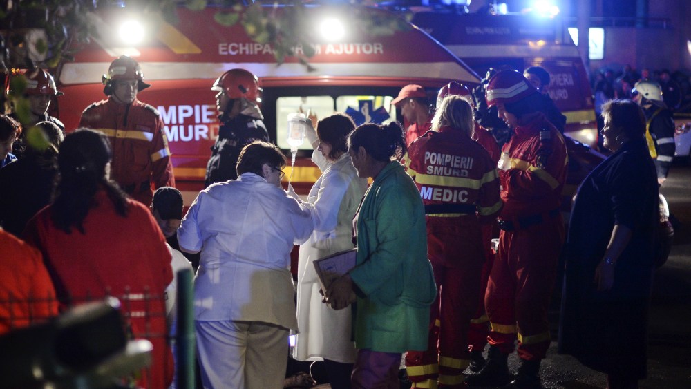 Emergency services work outside a nightclub in Bucharest