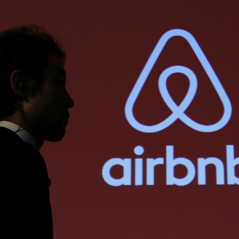 A man walks past a logo of Airbnb after a news conference in Tokyo, Japan, Nov. 26, 2015. (Photo by Yuya Shino/Reuters)