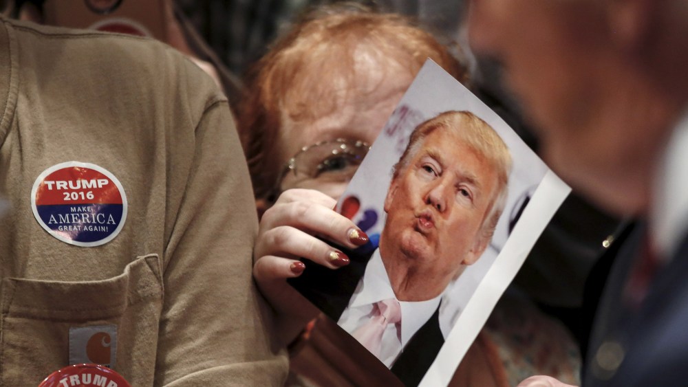 A woman works her way to the front of the crowd as Republican U.S. presidential candidate Donald Trump signs autographs after addressing a Trump for President campaign rally in Macon, Ga., Nov.30, 2015. (Photo by Christopher Aluka Berry/Reuters)