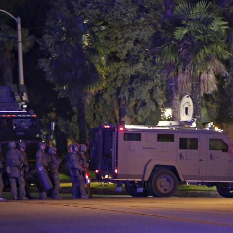 Police officers line the street outside the house of one of the suspects in a mass shooting in Redlands, Calif., Dec. 2, 2015. Gunmen opened fire on a holiday party on Wednesday, killing 14 people and wounding 17 others. (Photo by Mario Anzuoni/Reuters)