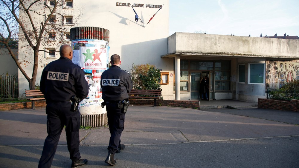 French police stand in front of the nursery school where a teacher claimed to have been assaulted by a hooded man with a knife, reportedly acting for Islamic State in Aubervilliers, near Paris, France, Dec. 14, 2015. (Photo by Charles Platiau/Reuters)