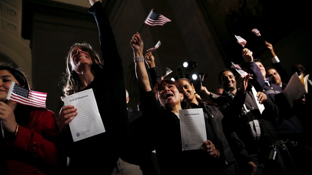 People celebrate as they become U.S. citizens during a naturalization ceremony at the National Archives Museum in Washington, Dec. 15, 2015. (Photo by Carlos Barria/Reuters)