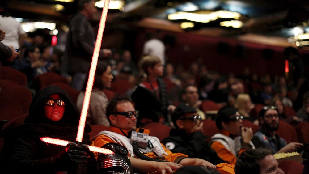 Moviegoers Dawn and Daniel Bright sit before the first showing of the movie "Star Wars: The Force Awakens" at the TCL Chinese Theatre in Hollywood, Calif., Dec. 17, 2015. (Photo by Mario Anzuoni/Reuters)