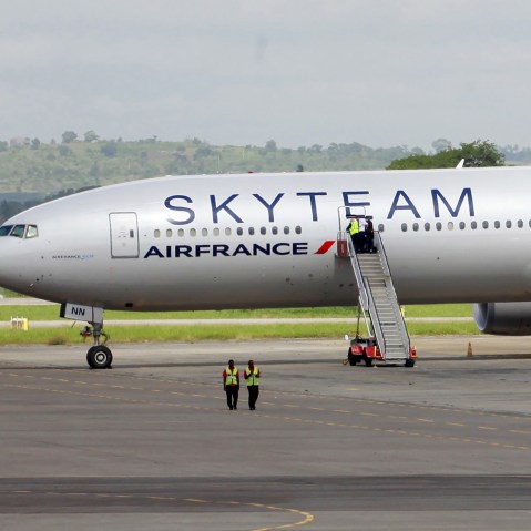 Airport workers are seen near the Air France Boeing 777 aircraft that made an emergency landing is pictured at Moi International Airport in Kenya's coastal city of Mombasa, Dec. 20, 2015. (Photo by Joseph Okanga/Reuters)