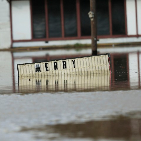 A sign sits underwater located in the downtown area of Elba, Ala., Dec. 26, 2015. (Photo by Marvin Gentry/Reuters)