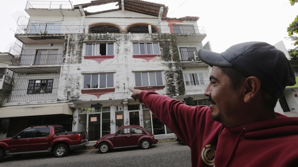 A resident points to where Ethan Couch, 18, and his mother, Tonya Couch stayed in the Pacific beach resort of Puerto Vallarta, Mexico, Dec. 30, 2015. (Photo by Henry Romero/Reuters)
