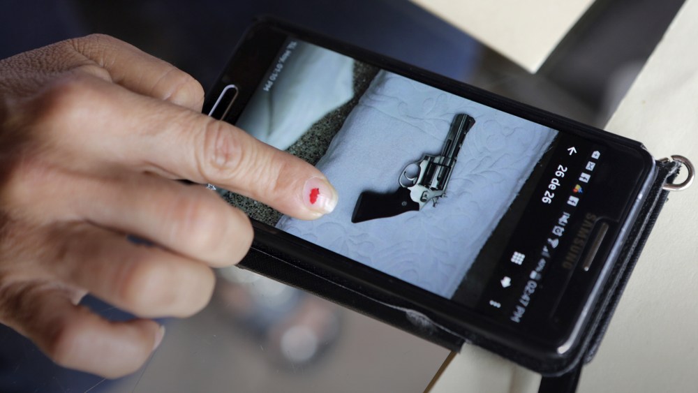 A Los Tules hotel staff member shows a photo taken with her phone of a gun found in a room where Ethan and Tonya Couch stayed for five days in the Pacific beach resort of Puerto Vallarta, Mexico, Dec. 30, 2015. (Photo by Henry Romero/Reuters)