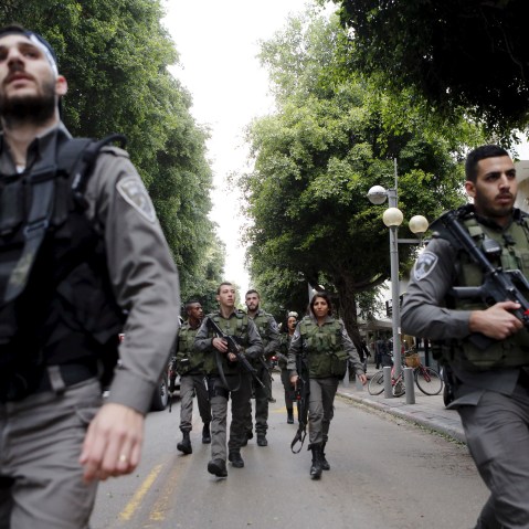 Israeli border police guards secure near the scene of a shooting incident in Tel Aviv, Israel Jan. 1, 2016. (Photo by Nir Elias/Reuters)