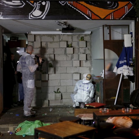Israeli forensic policemen work at the scene of a shooting incident in Tel Aviv, Israel, Jan. 1, 2016. (Photo by Baz Ratner/Reuters)