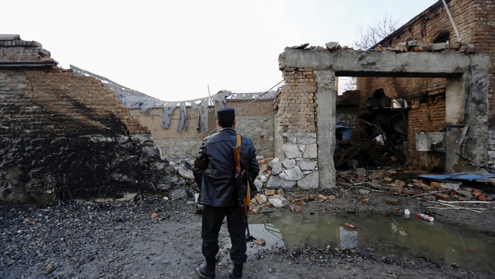An Afghan policeman stands guard in front of a French restaurant "Le Jardin" after a Taliban suicide attack in Kabul, Afghanistan, Jan. 2, 2016. (Photo by Mohammad Ismail/Reuters)