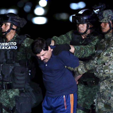 Joaquin "El Chapo" Guzman is escorted by soldiers during a presentation at the hangar belonging to the office of the Attorney General in Mexico City, Mexico, Jan. 8, 2016. (Photo by Edgard Garrido/Reuters)