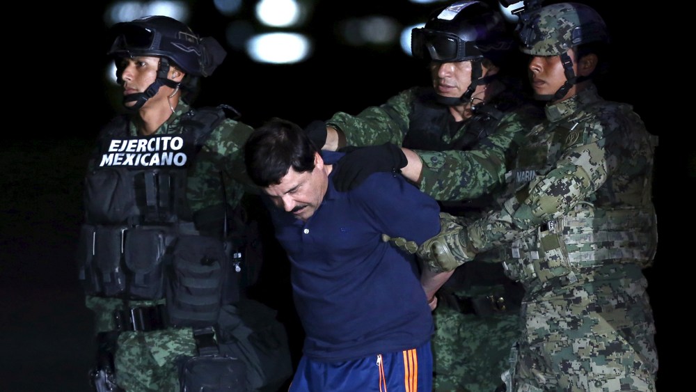 Joaquin "El Chapo" Guzman is escorted by soldiers during a presentation at the hangar belonging to the office of the Attorney General in Mexico City, Mexico, Jan. 8, 2016. (Photo by Edgard Garrido/Reuters)