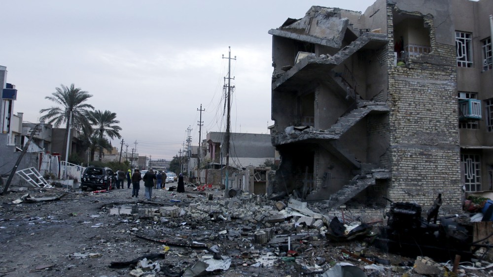 People gather at the site of a car bomb blast in New Baghdad, Jan. 12, 2016. (Photo by Khalid al Mousily/Reuters)