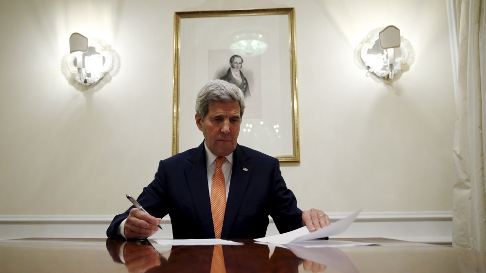 Secretary of State John Kerry signs the certification to the U.S. government that  IAEA certified Iran's compliance in their report, requesting the lifting of the nuclear-related sanctions, Vienna, Jan. 16, 2016. (Photo by Kevin Lamarque/Reuters)