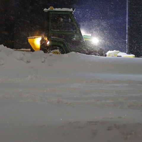 A snow plow clears a sidewalk of snow in the Manhattan borough of New York, Jan. 23, 2016. (Photo by Carlo Allegri/Reuters)