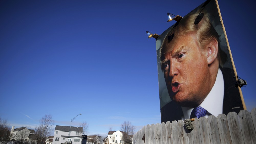 A large poster of Republican presidential candidate Donald Trump is displayed in a residential neighborhood in West Des Moines, Iowa, Jan. 28, 2016. (Photo by Brian Snyder/Reuters)