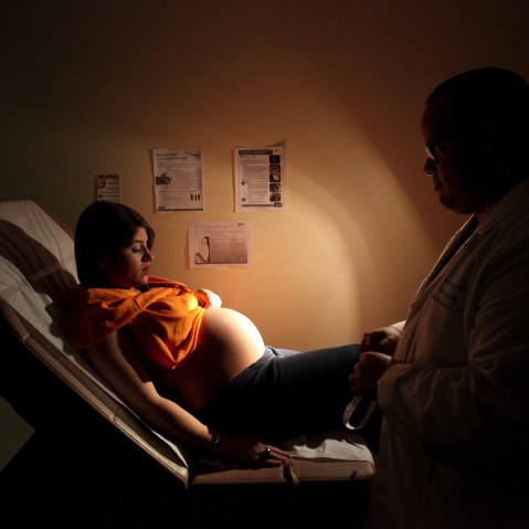 Noriany Rivera, who is 40 weeks pregnant, listens to a doctor during a check up, as fliers explaining how to prevent Zika, Dengue and Chikungunya viruses are posted on the wall, in San Juan, Puerto Rico, Feb. 3, 2016. (Photo by Alvin Baez/Reuters)