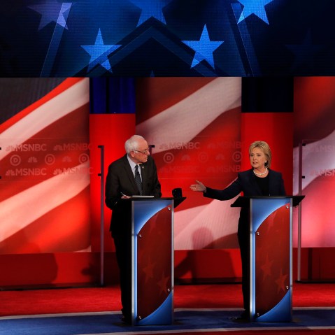 Candidate Hillary Clinton speaks as Bernie Sanders listens at the MSNBC Presidential debate at the University of New Hampshire in Durham, N.H., Feb. 4, 2016. (Photo by Mike Segar/Reuters)