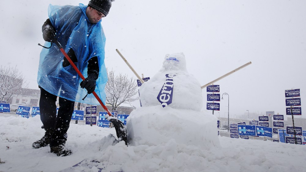 A worker builds a snow man of Democratic presidential candidate Bernie Sanders during a snow storm in Manchester, N.H., Feb. 5, 2016. (Photo by Carlo Allegri/Reuters)
