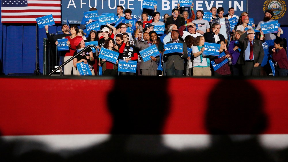 Shadows loom over supporters of Democratic presidential candidate Bernie Sanders at his 2016 New Hampshire presidential primary night rally in Concord, N.H., Feb. 9, 2016. (Photo by Shannon Stapleton/Reuters)