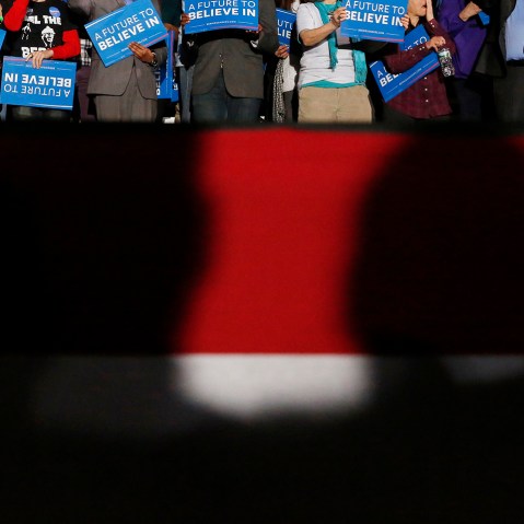 Shadows loom over supporters of Democratic presidential candidate Bernie Sanders at his 2016 New Hampshire presidential primary night rally in Concord, N.H., Feb. 9, 2016. (Photo by Shannon Stapleton/Reuters)