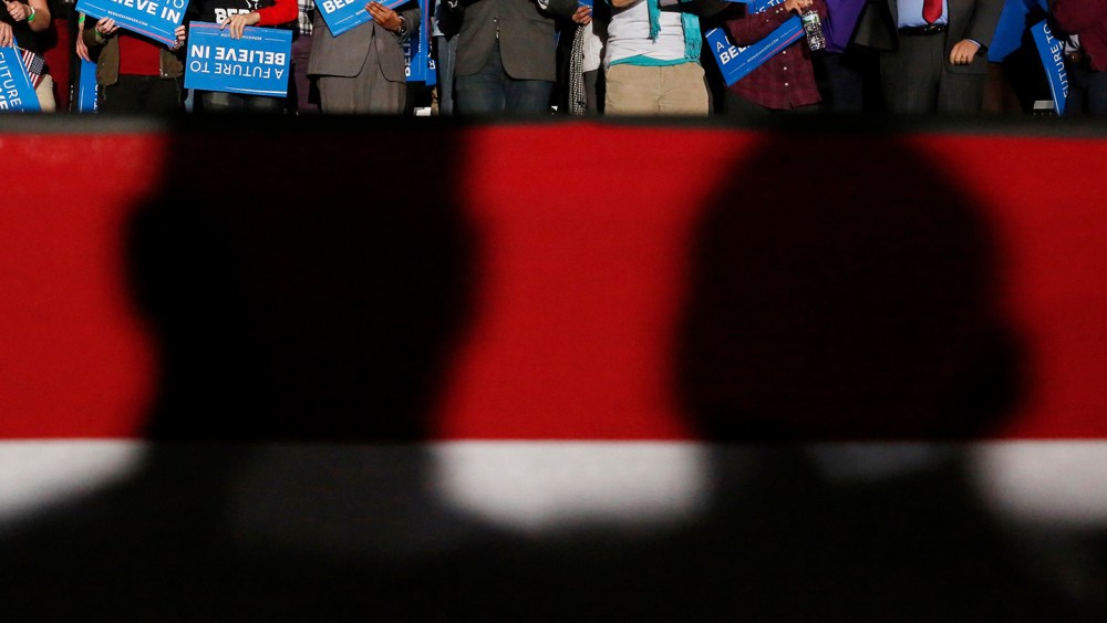 Shadows loom over supporters of Democratic presidential candidate Bernie Sanders at his 2016 New Hampshire presidential primary night rally in Concord, N.H., Feb. 9, 2016. (Photo by Shannon Stapleton/Reuters)