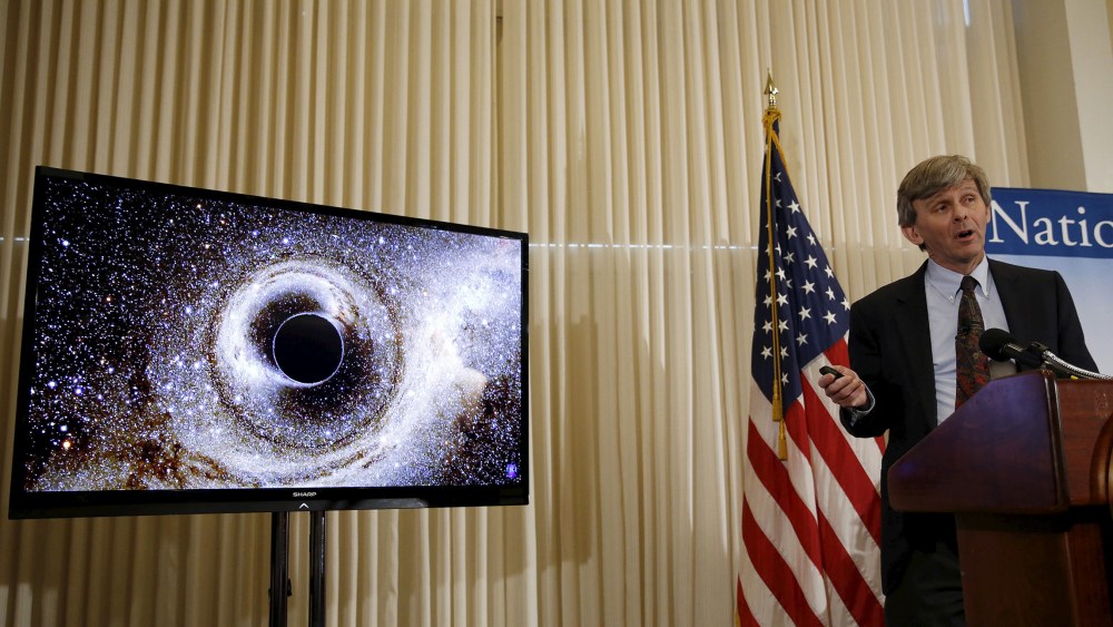 Dr. David Reitze, Executive Director of the Caltech LIGO Laboratory, shows the merging of two black holes , discussing the detection of gravitational waves, as hypothesized by Albert Einstein, Feb. 11, 2016. (Photo by Gary Cameron/Reuters)