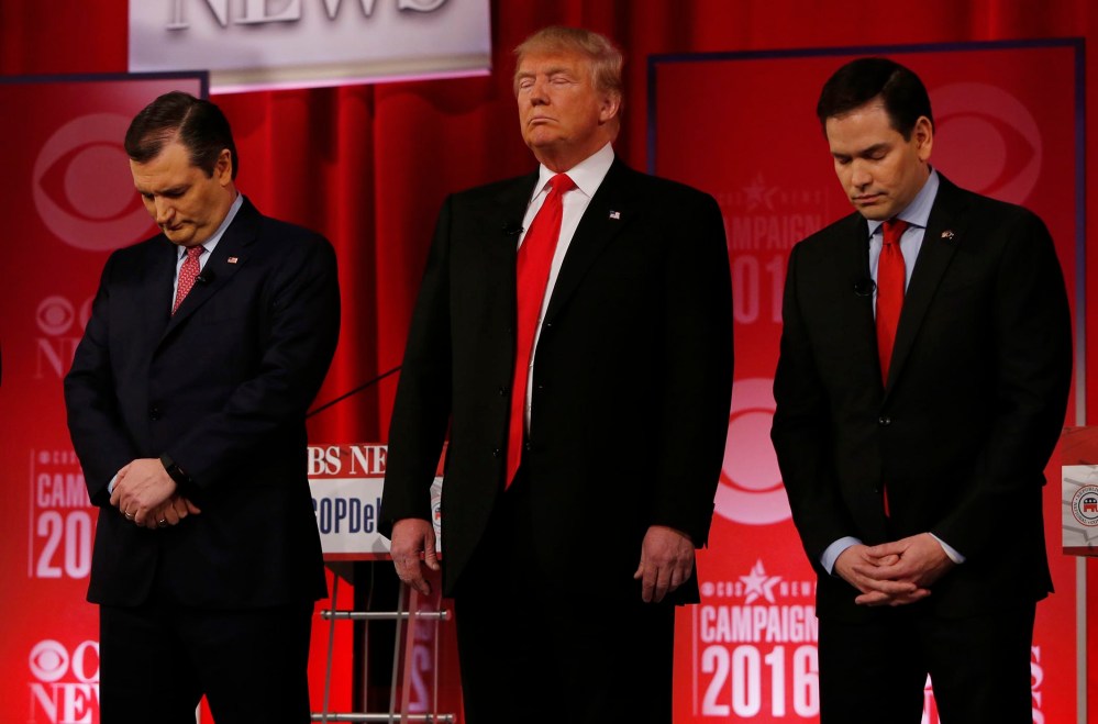 Republican presidential candidates Sen. Ted Cruz, Donald Trump and Sen. Marco Rubio pause in honor of Supreme Court Associate Justice Antonin Scalia before the start of the Republican presidential debate, Feb. 13, 2016. (Photo by Jonathan Ernst/Reuters)