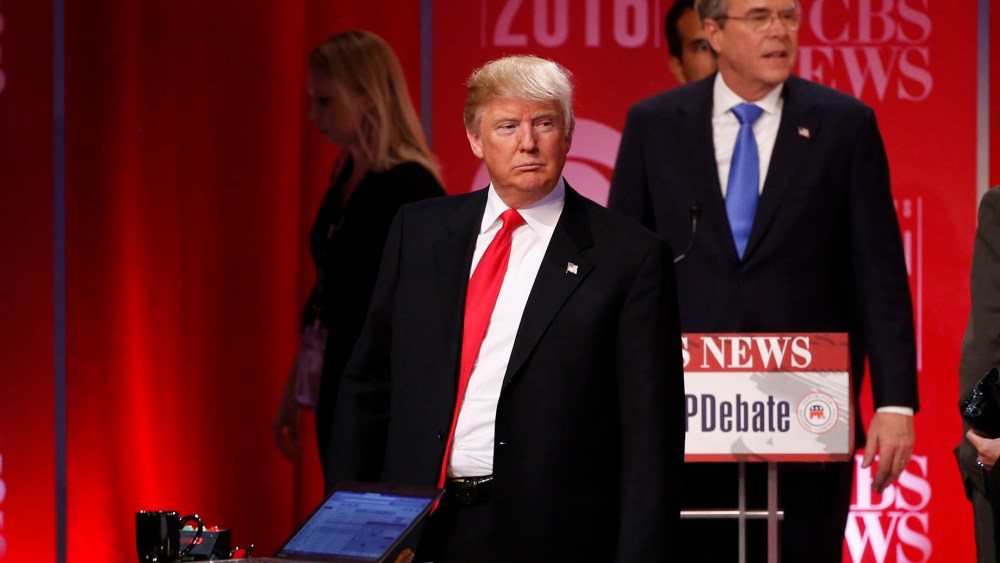 Republican U.S. presidential candidate former Governor Jeb Bush walks past rival candidate businessman Donald Trump as he stands at the front of the stage at the conclusion of the debate, Feb. 13, 2016. (Photo by Jonathan Ernst/Reuters)