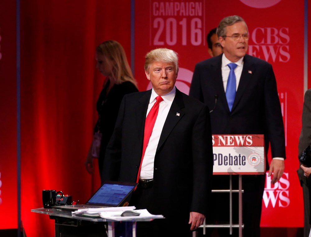 Republican U.S. presidential candidate former Governor Jeb Bush walks past rival candidate businessman Donald Trump as he stands at the front of the stage at the conclusion of the debate, Feb. 13, 2016. (Photo by Jonathan Ernst/Reuters)