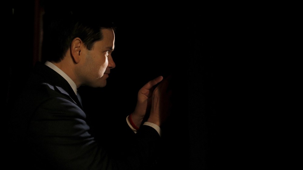 Republican presidential candidate Marco Rubio peeks through curtains before being introduced during a campaign event in Reno, Nev., Feb. 22, 2016. (Photo by Chris Keane/Reuters)
