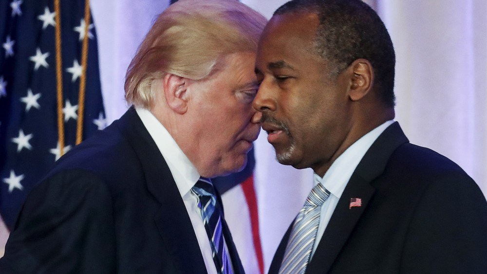 Republican U.S. presidential candidate Donald Trump walks behind former Republican presidential candidate Ben Carson after receiving Carson's endorsement at a campaign event in Palm Beach, Fl., March 11, 2016. (Photo by Carlo Allegri/Reuters)